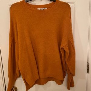 Burnt orange/yellow sweater with puffy sleeves. Size large.